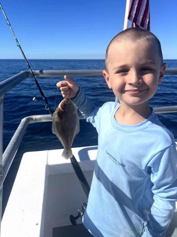 Kids enjoying a fishing trip near Daytona Beach, smiling and holding their catch